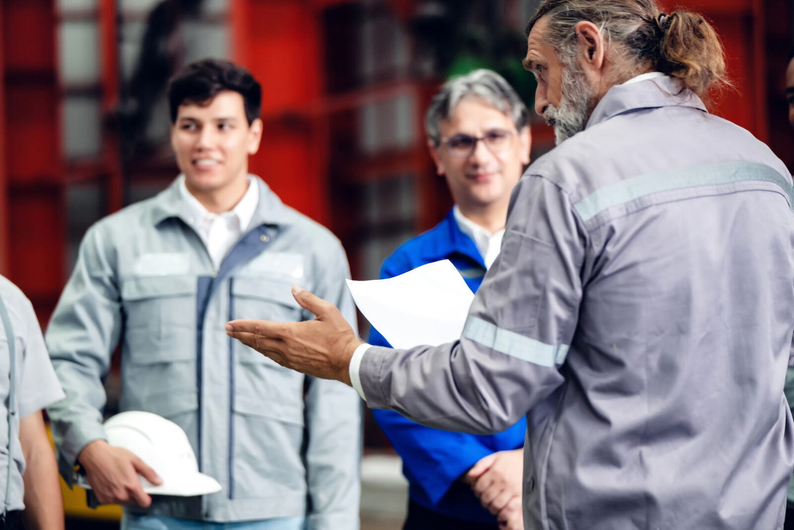 Manufacturing team reviewing plans on the shop floor