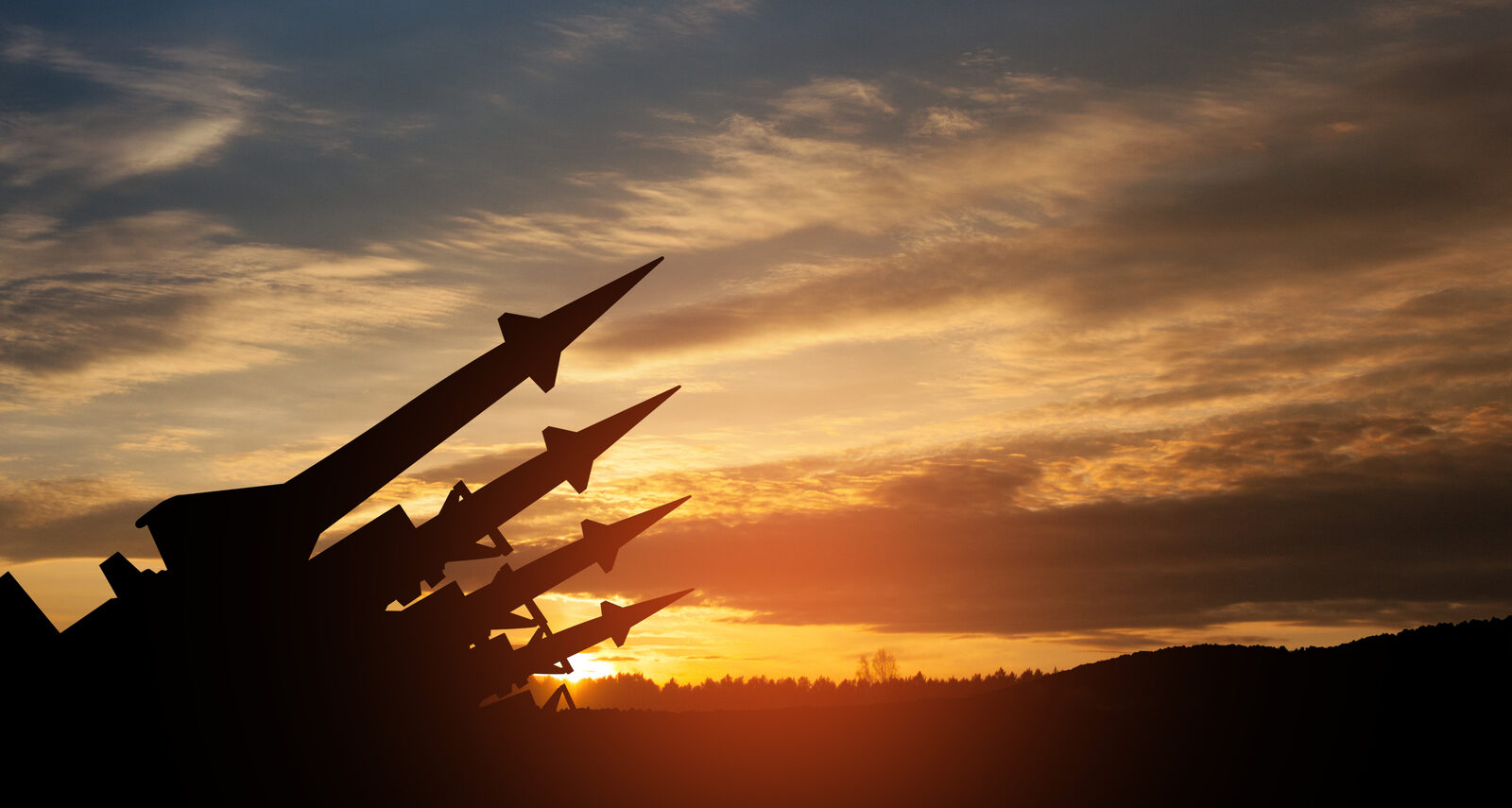 Missile defense systems silhouetted at dusk