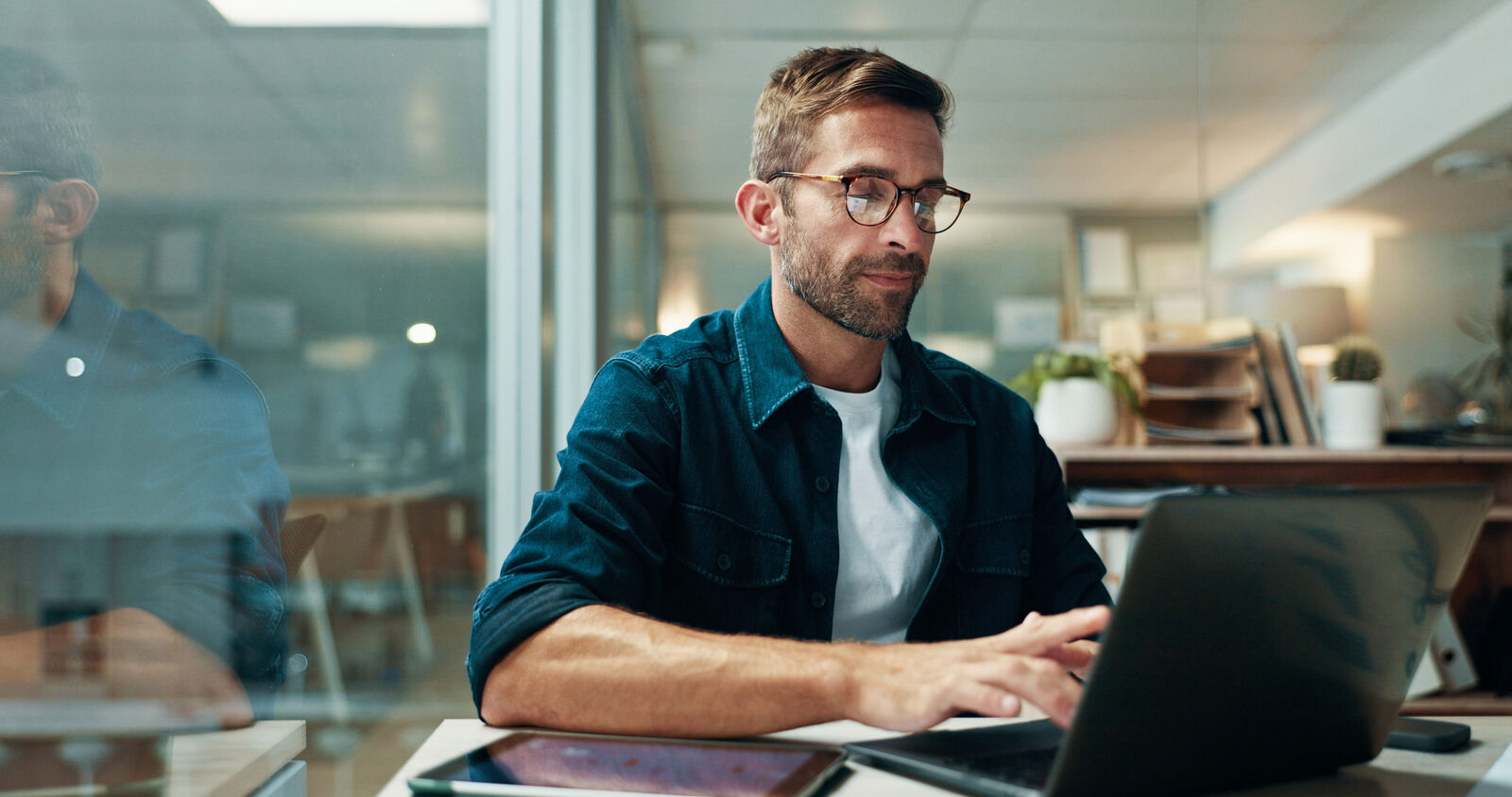 Procurement professional working at a laptop