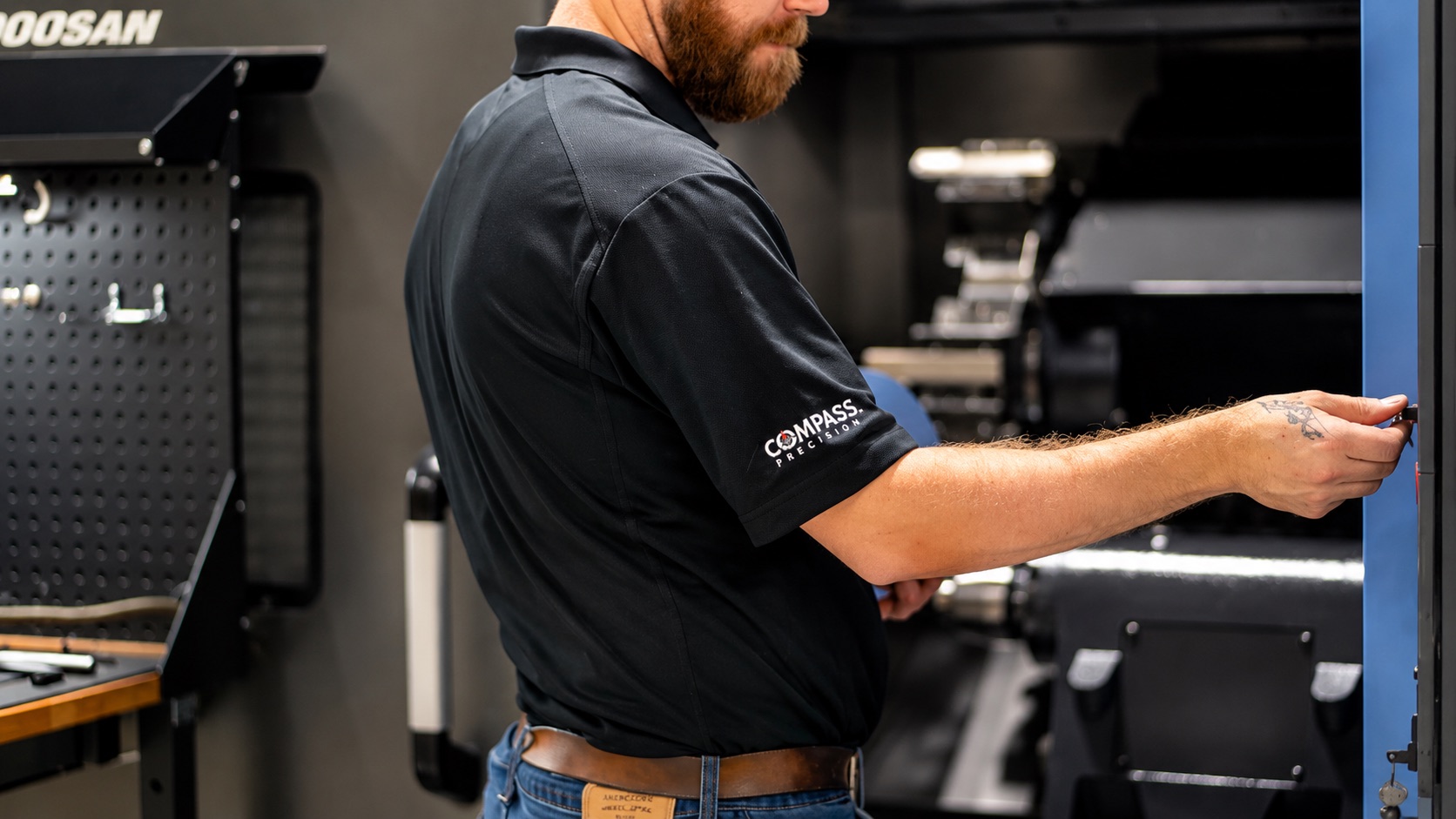 Compass Precision machinist working at a CNC machine