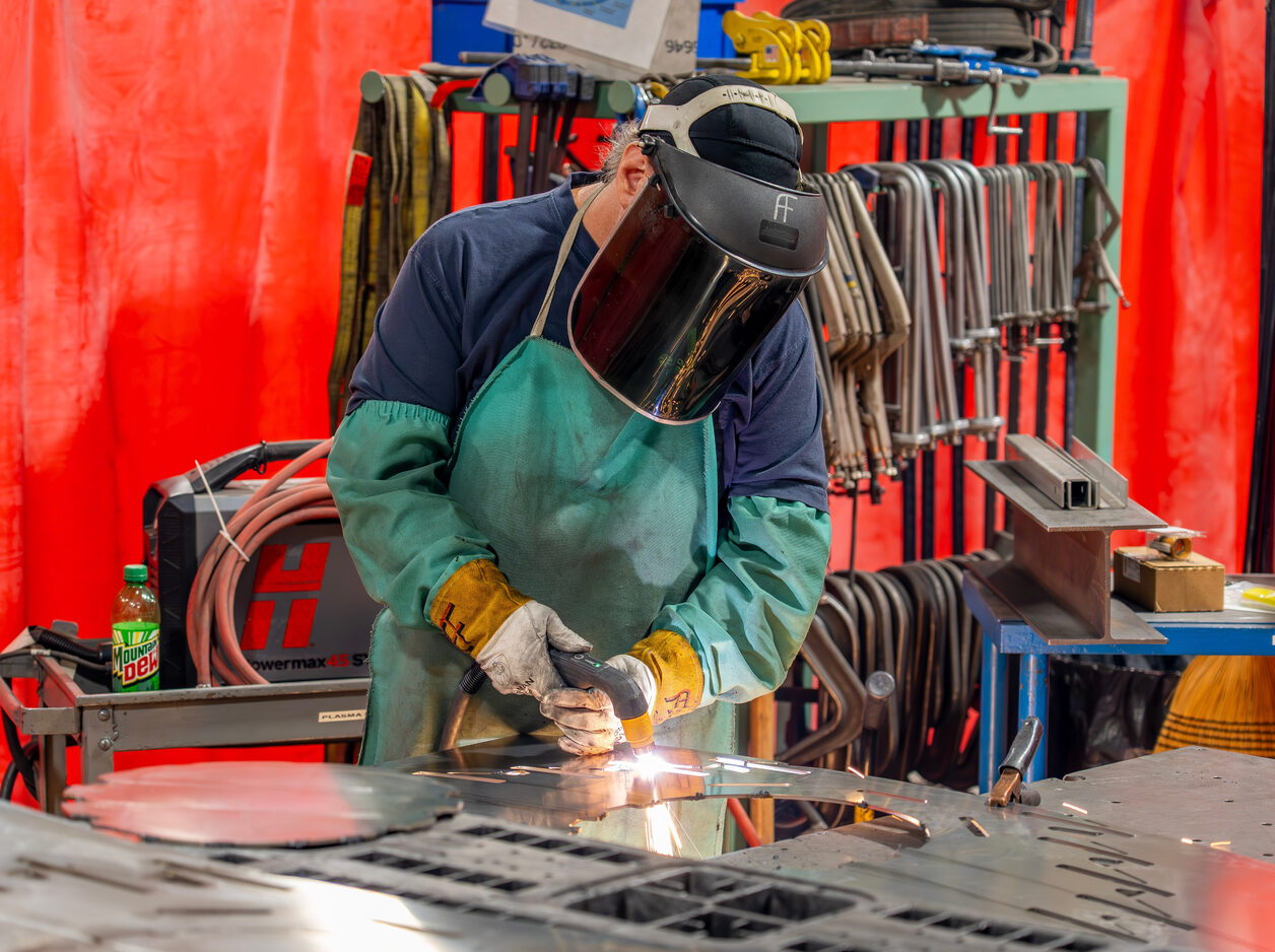 Welder joining fabricated sheet metal components at a Compass Precision facility
